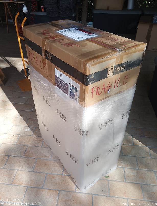 Credenzina in legno in fase di imballaggio extra con pluriball, bolle aria e angolari protettivi, i vetri vengono smontati, nei magazzini di Arredamentishop.it